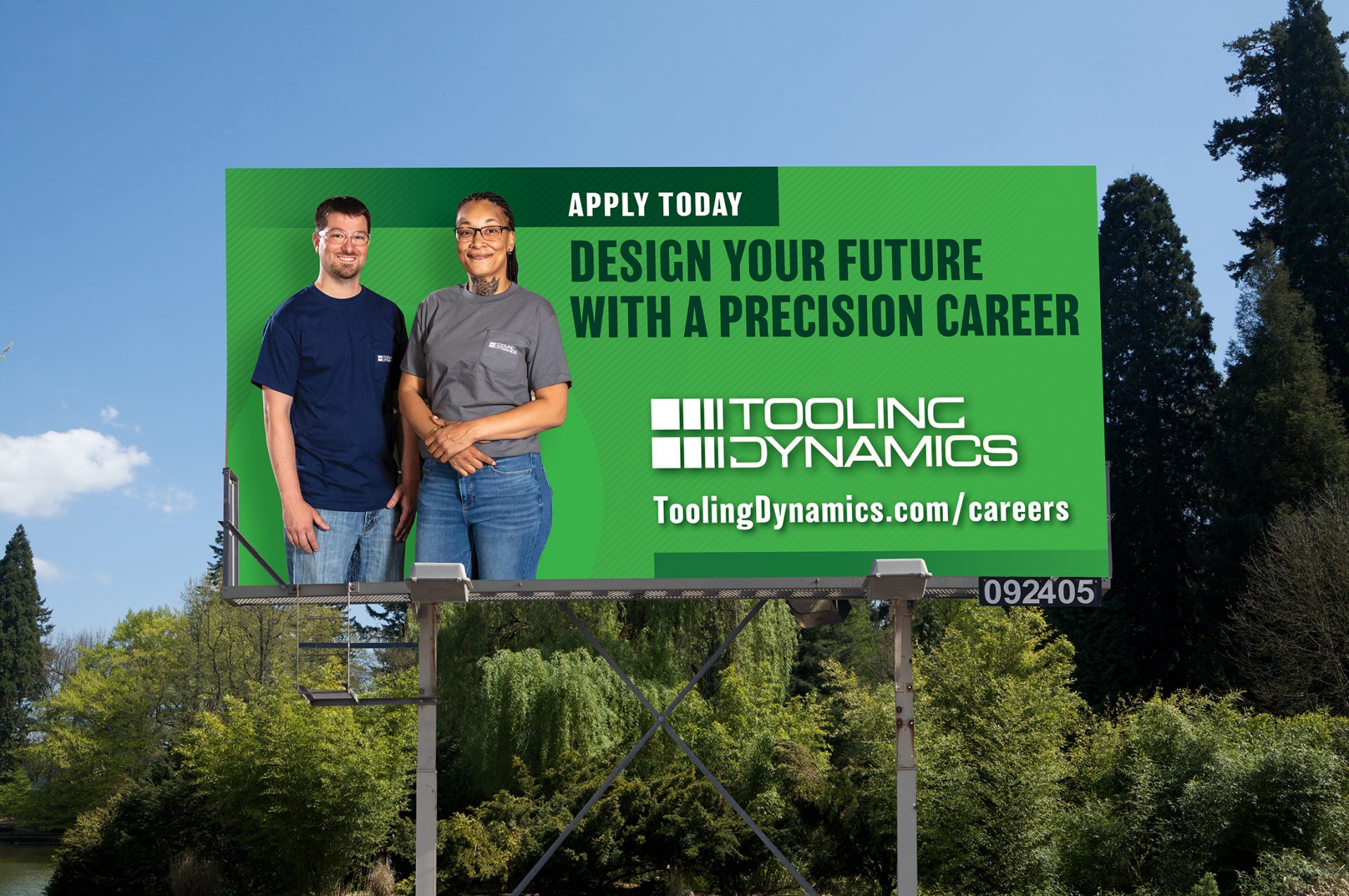 Billboard with two people on a green background. Text reads: Design your future with a precision career. Apply Now. Tooling Dynamics" 