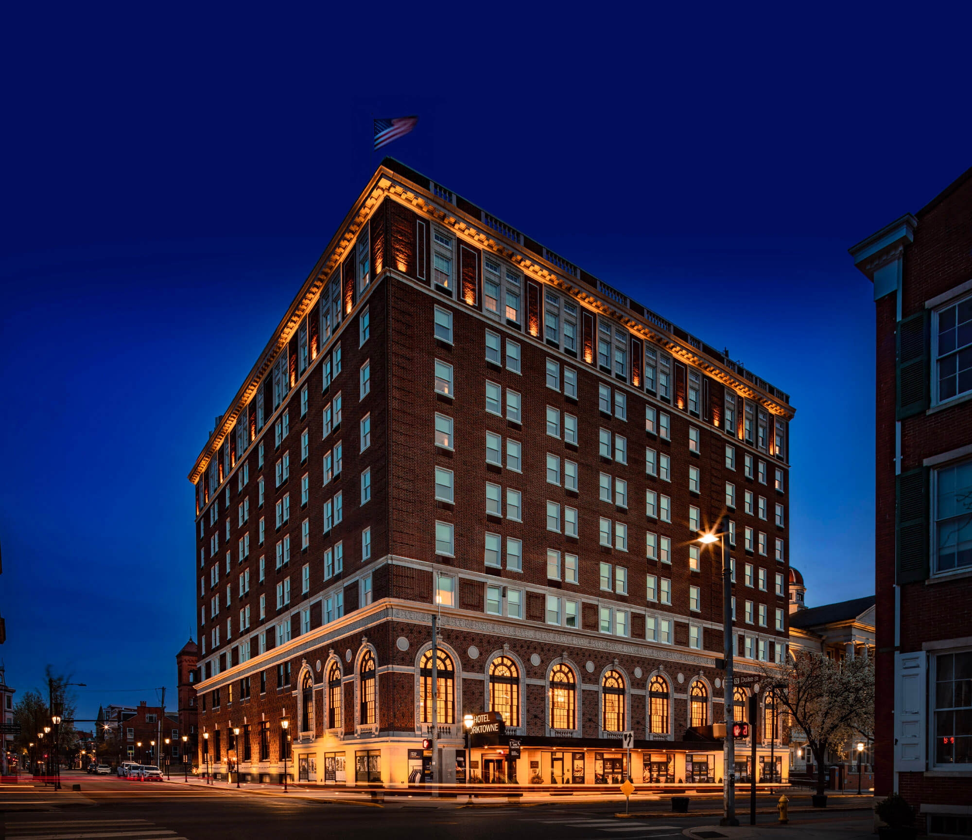 A twilight shot of the outside of the Yorktowne Hotel building.