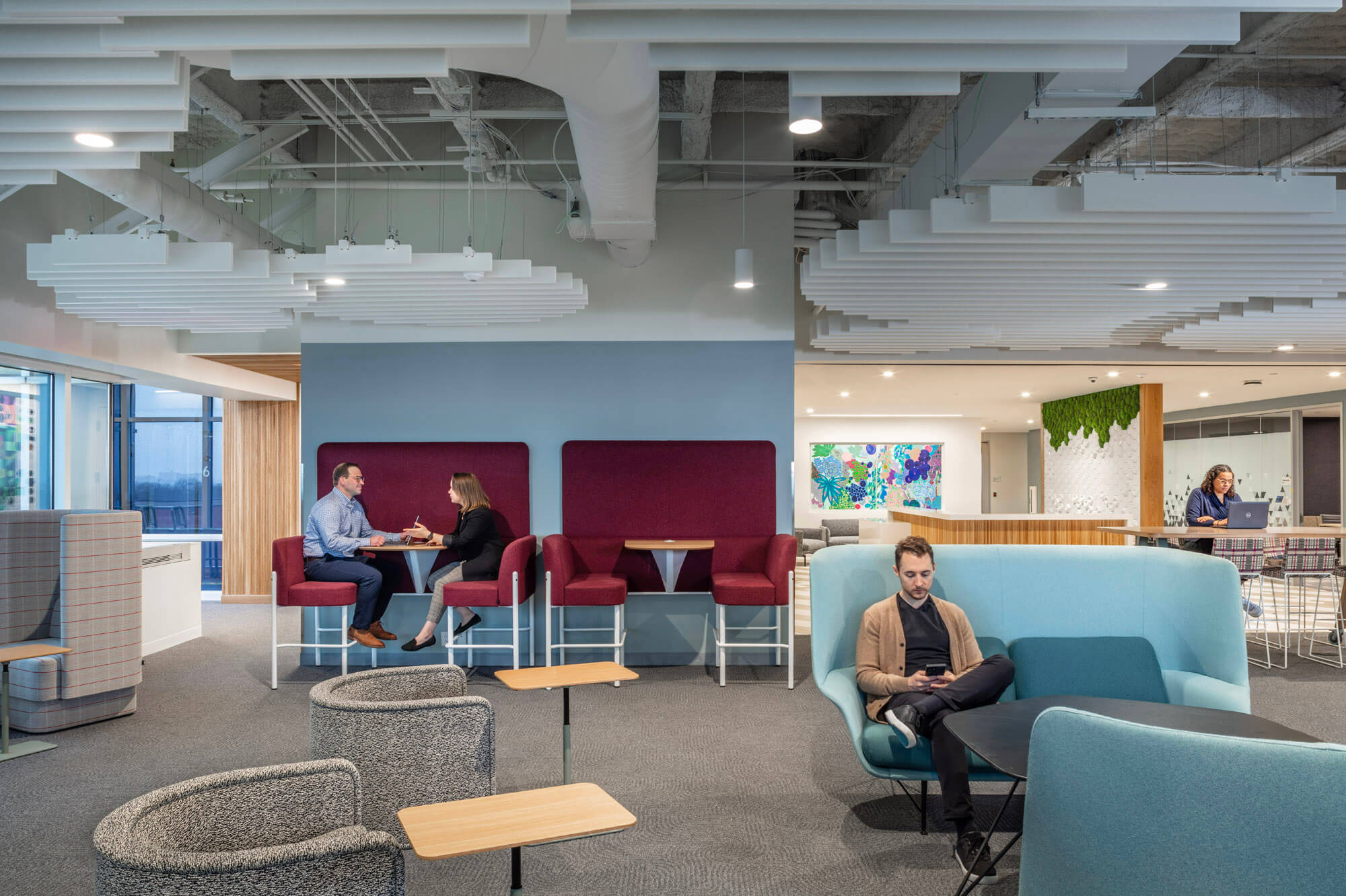 Open plan office space with booths and various types of seating.