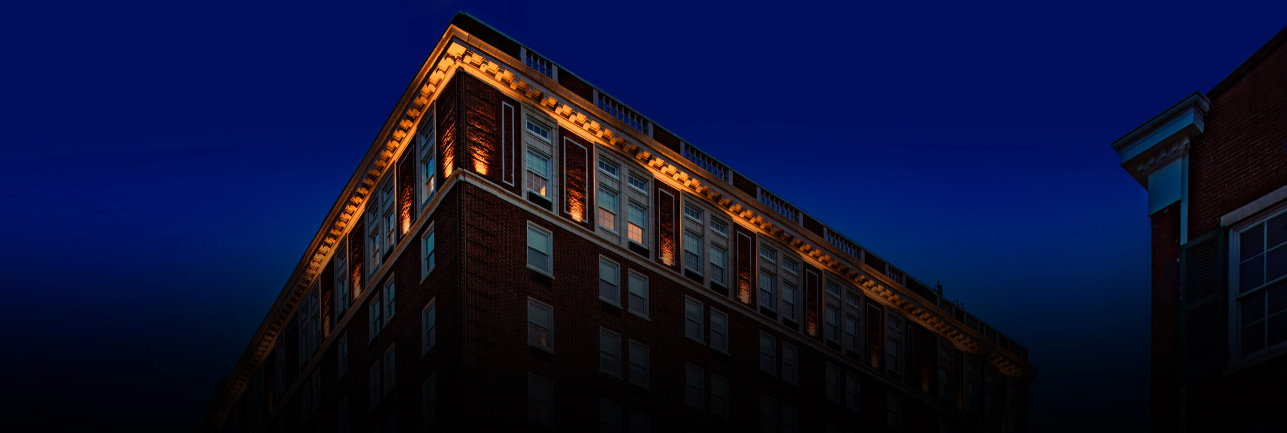 The Yorktowne hotel from the outside at dusk with all the lights of the hotel shining.