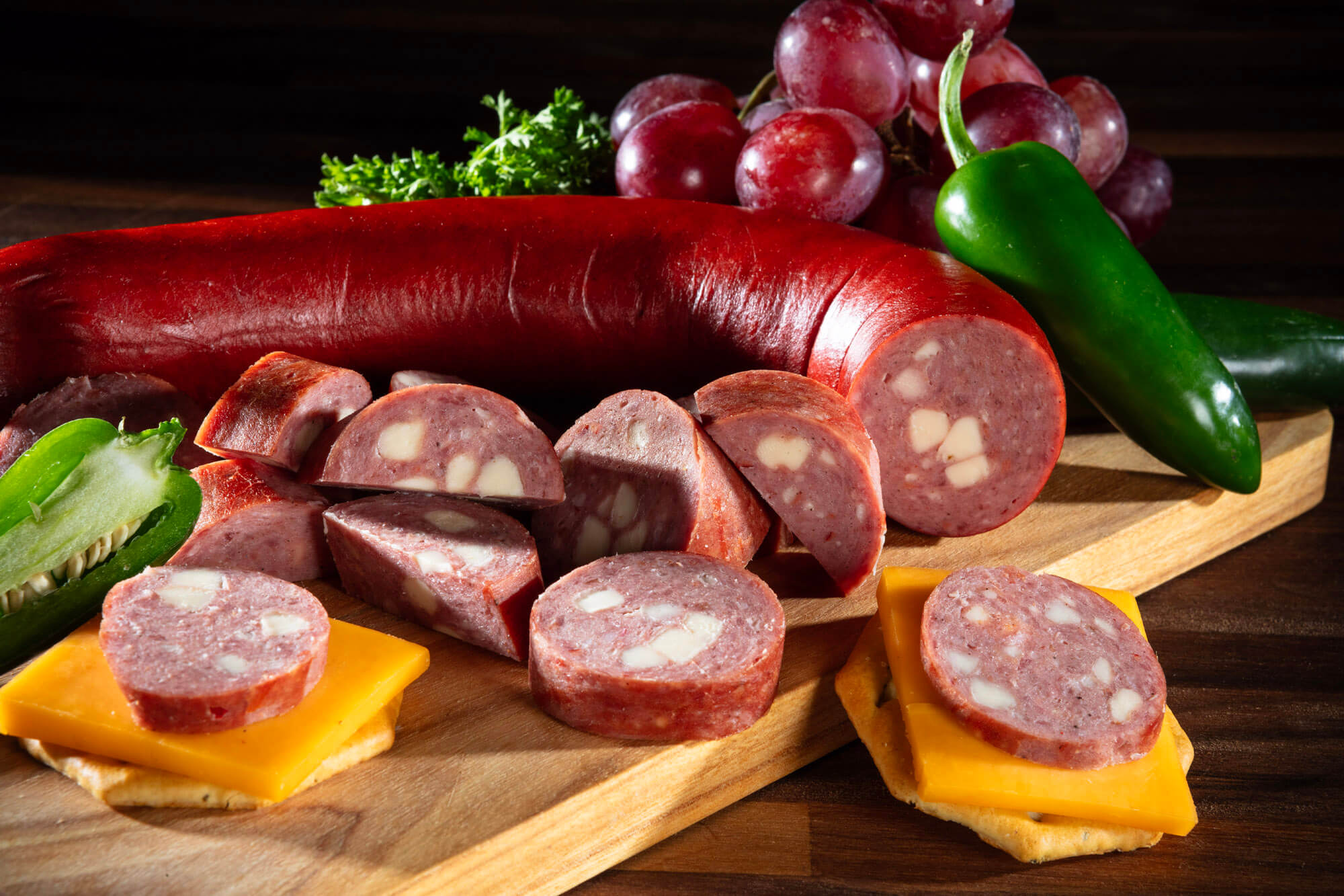 A salami, chees, crackers in a display