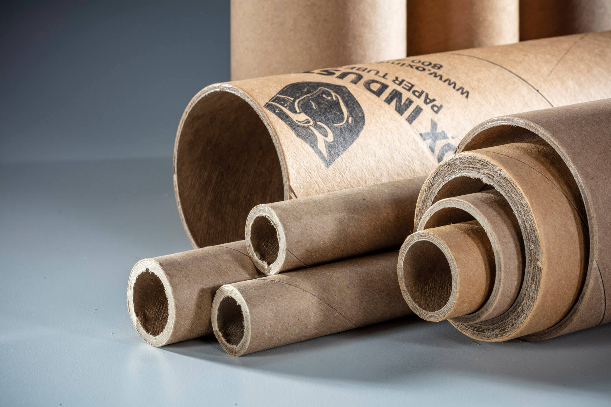 A selection of different sized carboard tubes all laying inside each other.