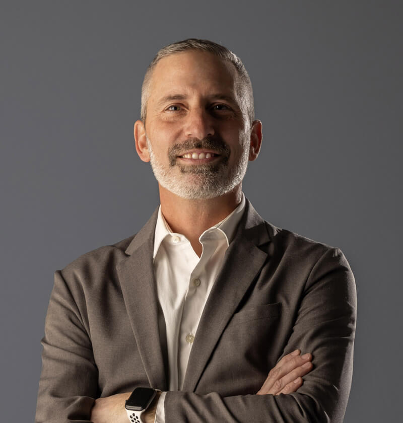 Man in a sports coat smiling at the camera