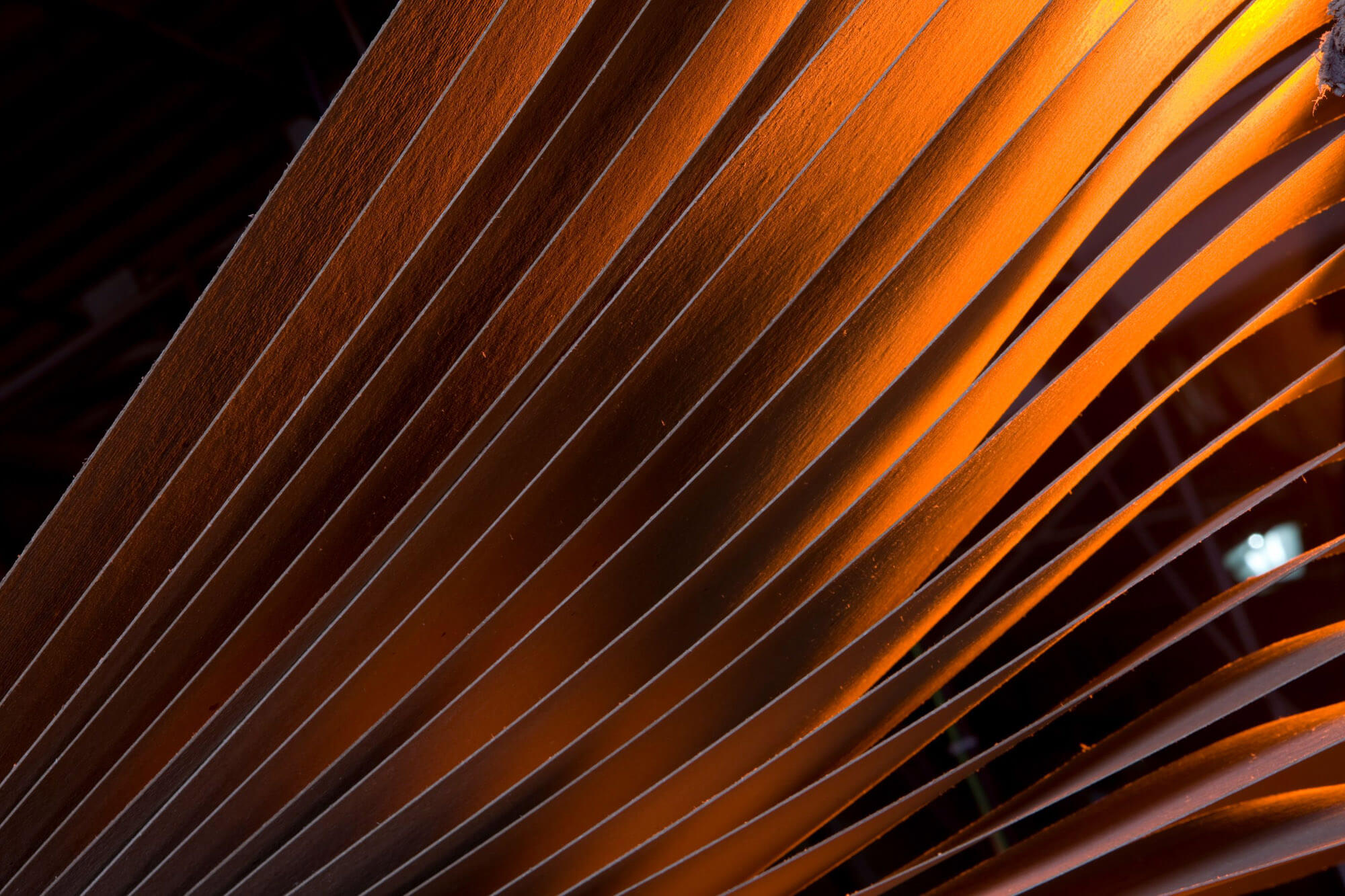 A close up shot of many sheets of cardboard and the light is coming through from the back.