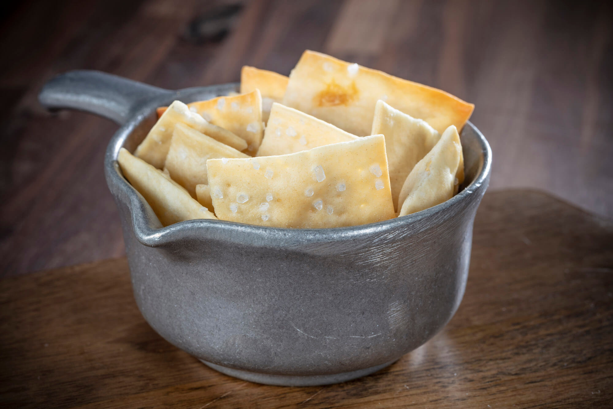 A metal container with crackers in.