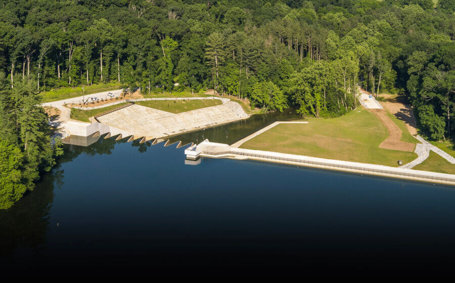 A drone shot of the Lake with a dam.