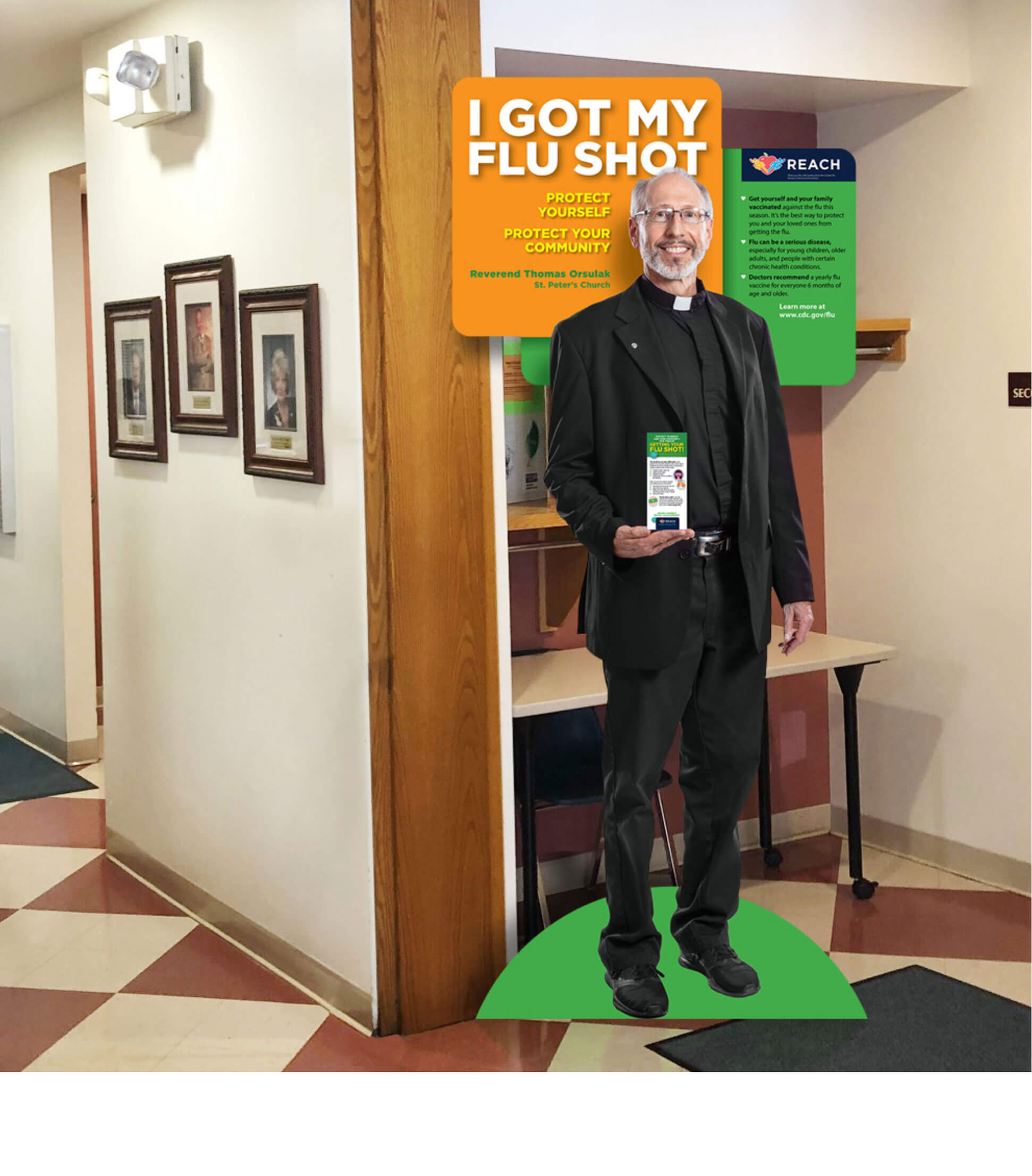 A room containing a life size cut out of a priest holding some brochures to advertise getting a flue shot.