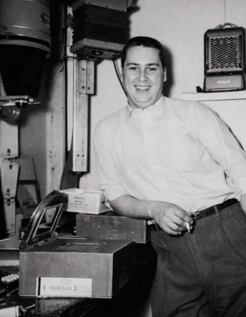 Jim Hayman Jr. smiling in the studio developing film.