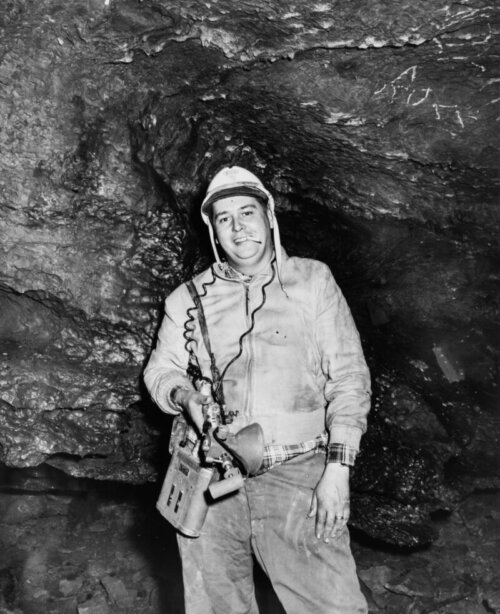 Jim Hayman Jr. in a coal mine all dirty on a shoot with his camera.