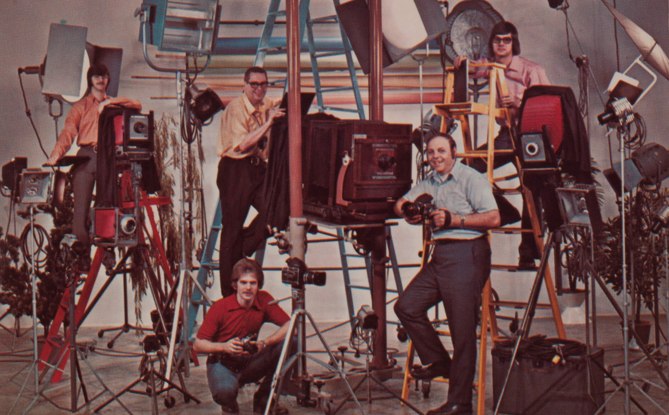 Five men standing in the studio surrounded by all their camera and lighting equipment in the 1970's.