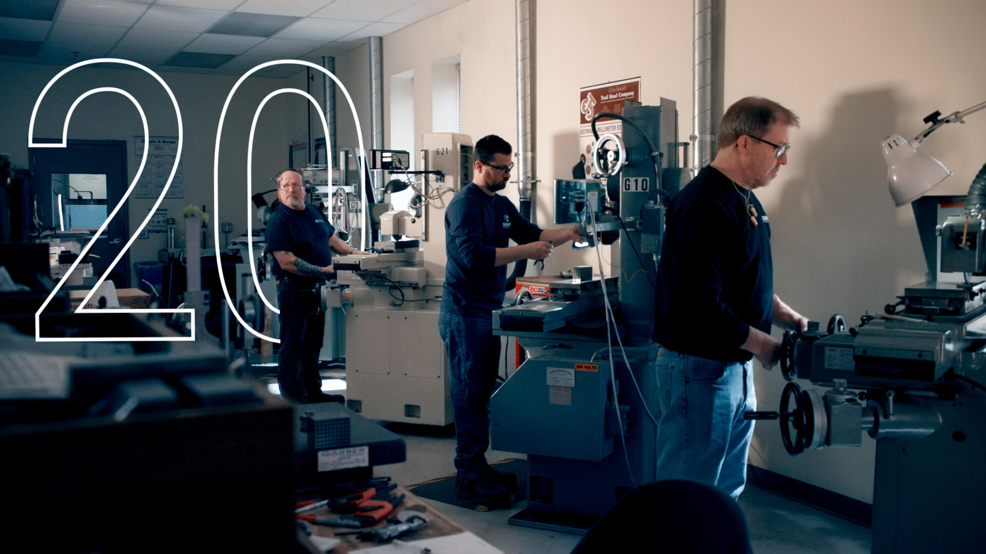 Three men working at their machines for the commercial video shoot.