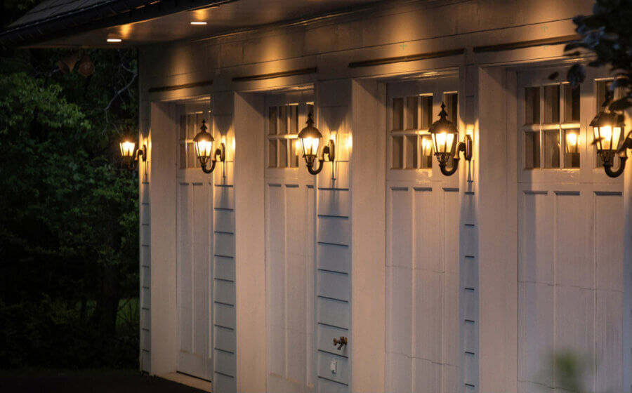 An image of a 4 car garage with Hanover Lantern lights between each door.