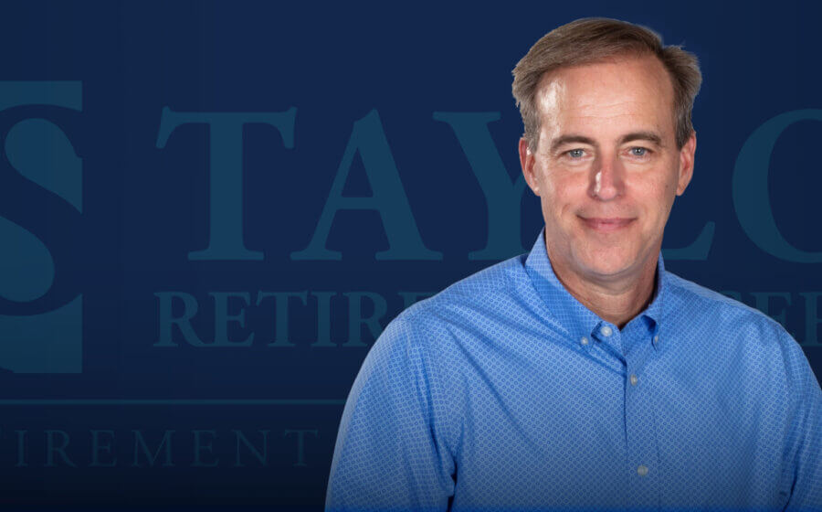A man smiling with the TRS logo in the background.